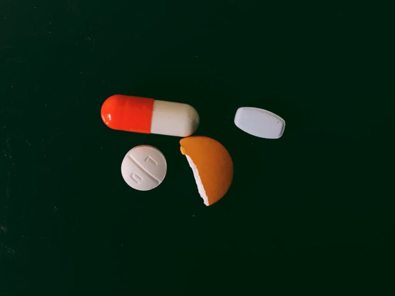 a group of pills on a green surface